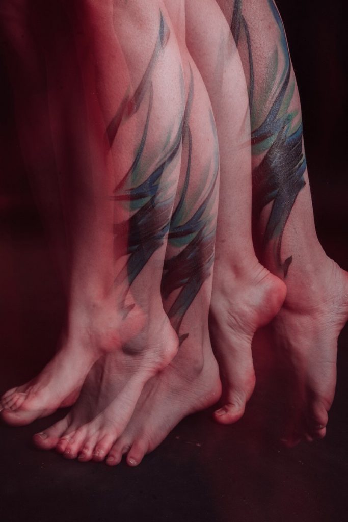 Abstract tattoo and artistic picture on a leg, ankle of a woman.